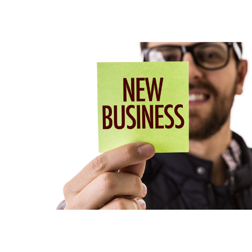 Man holding paper that says New Business